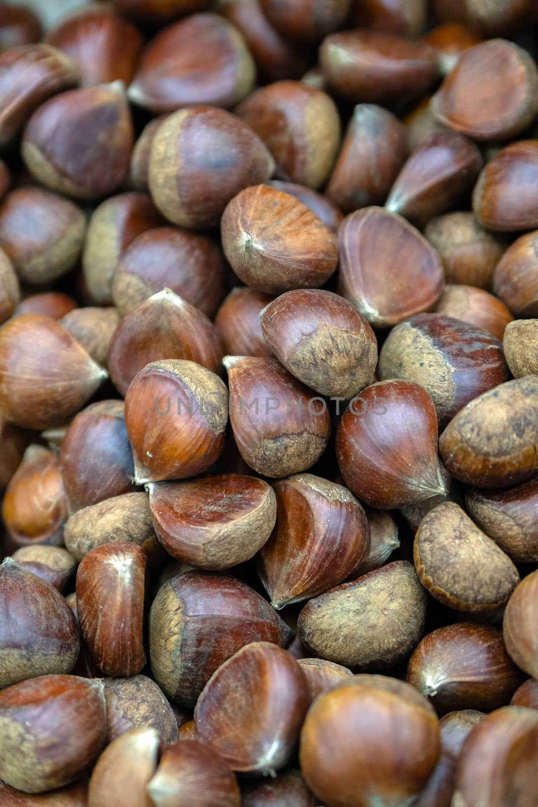 Chestnuts in basket in supermarket, first-person view, closeup