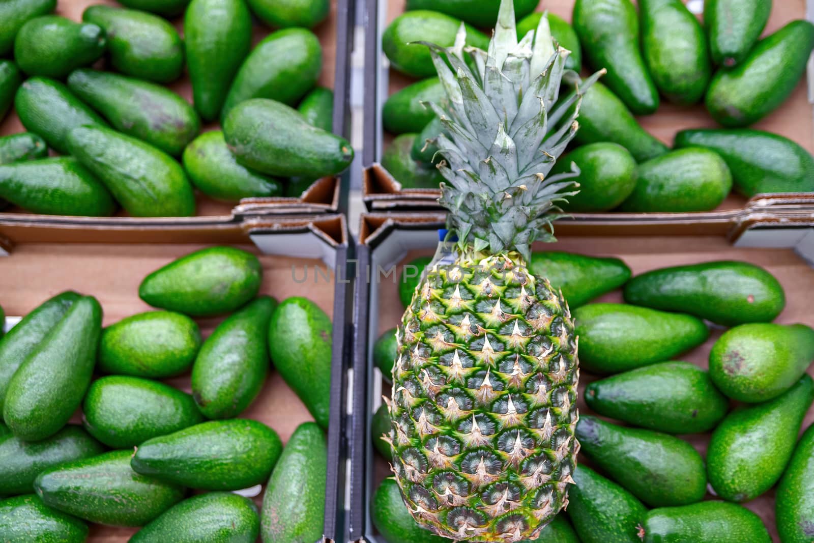 Fresh pineapple on shelves in supermarket. by bonilook
