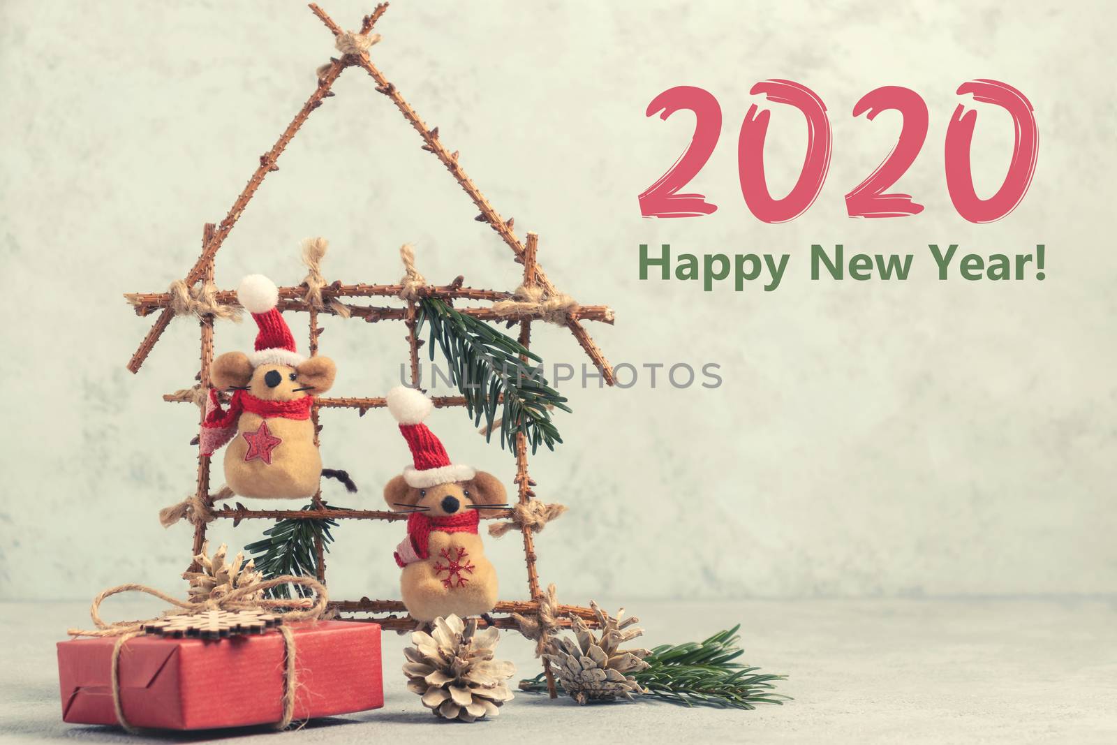 Two Little toy Christmas mice, gift and decorations from natural materials on table. Christmas composition with symbol 2020 of Chinese horoscope by galsand