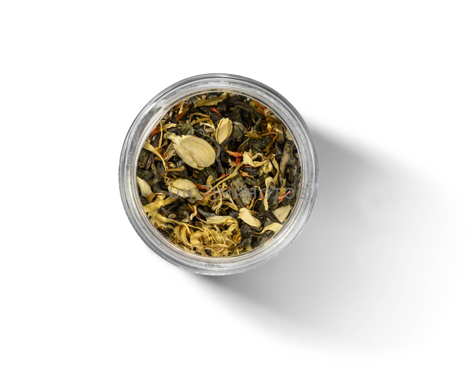 Green tea with aromatic additives. Top view on white background.
