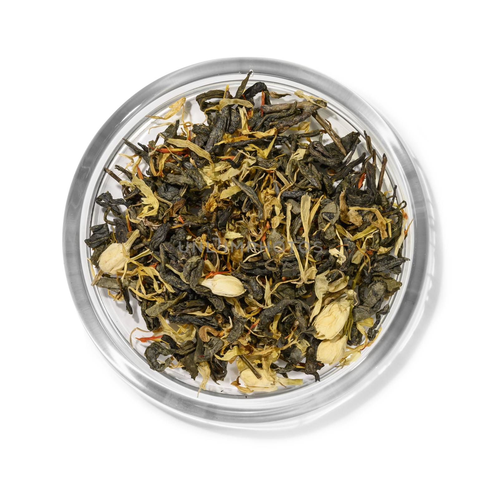 Green tea with aromatic additives. Top view on white background.