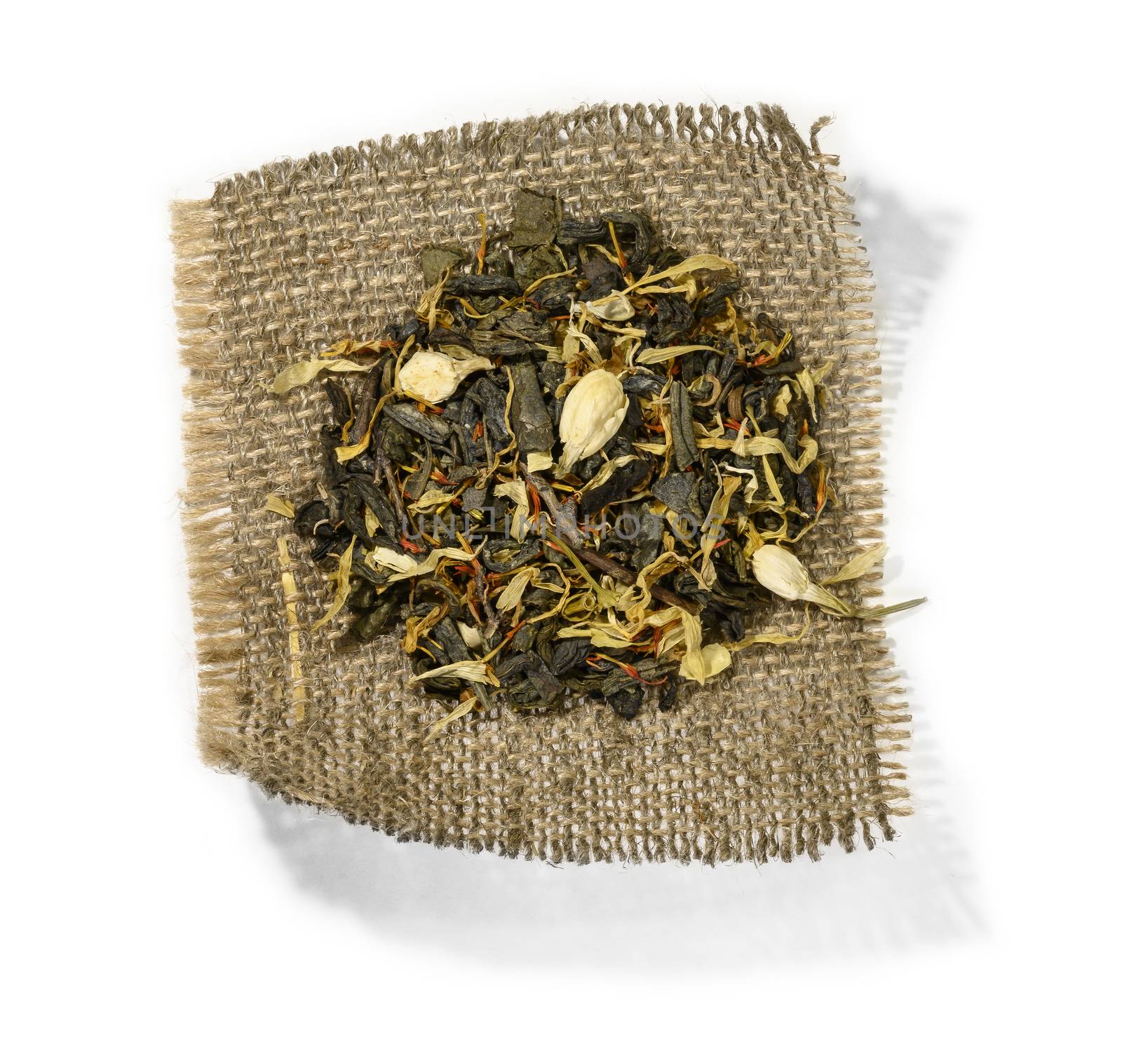 Green tea with aromatic additives. Top view on white background.