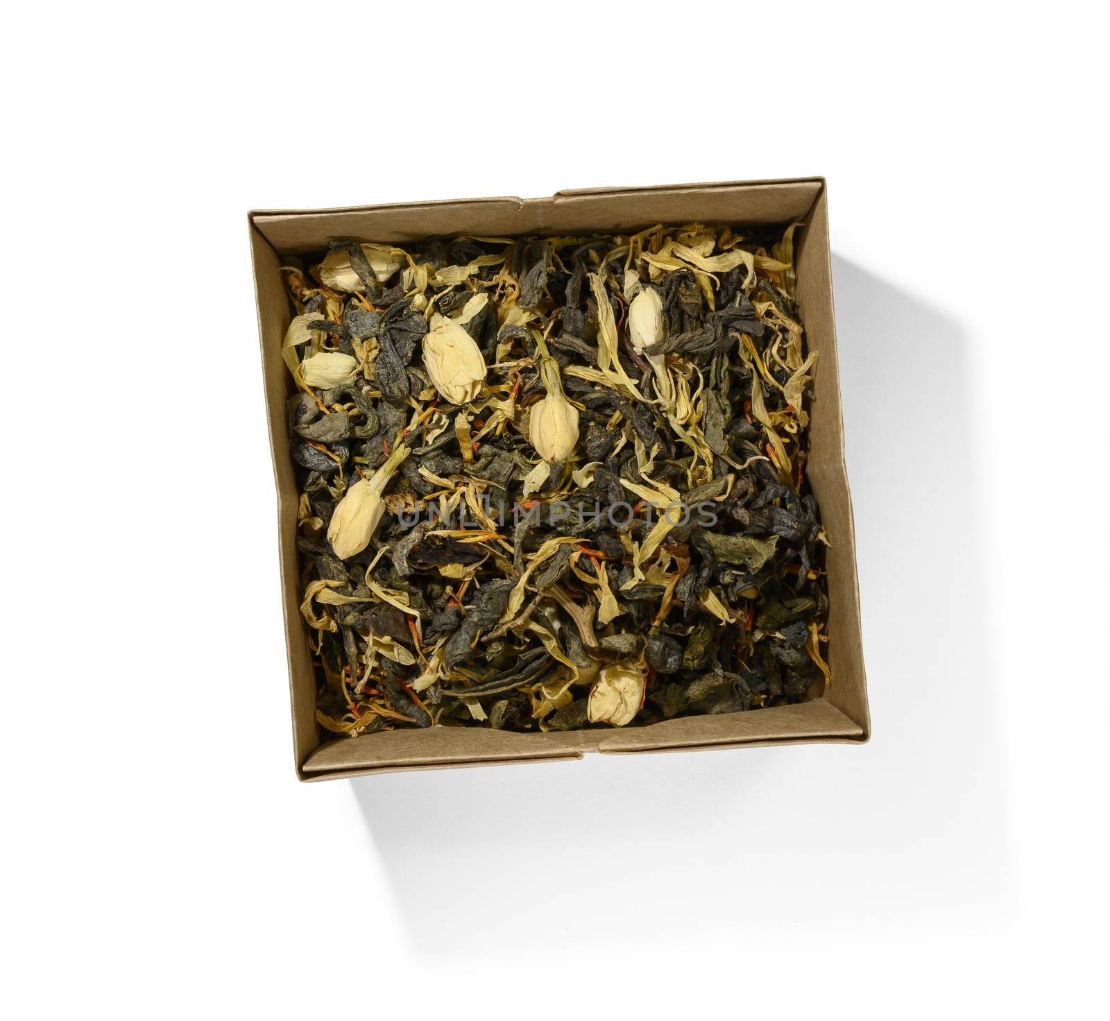 Green tea with aromatic additives. Top view on white background.
