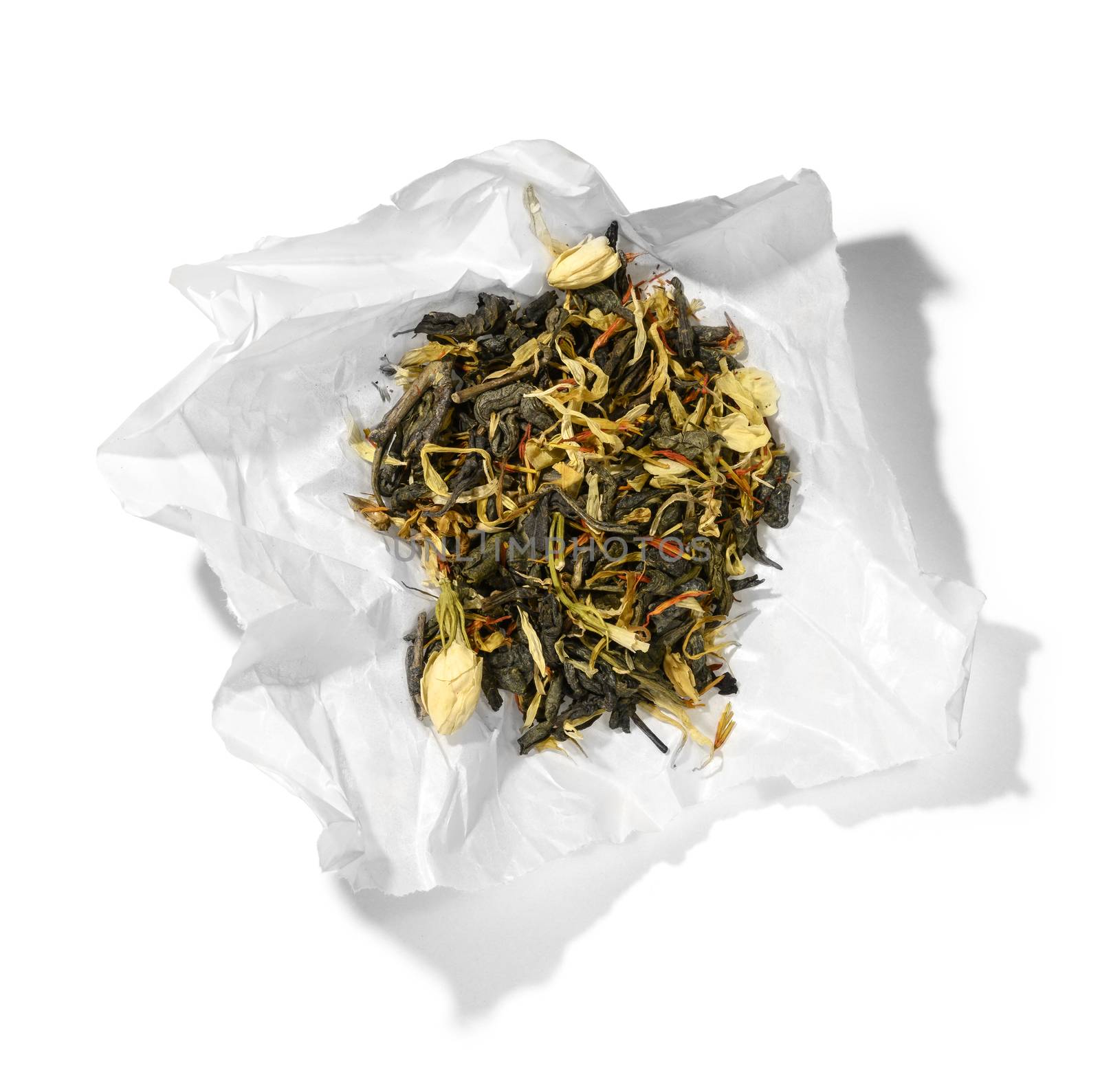 Green tea with aromatic additives. Top view on white background.
