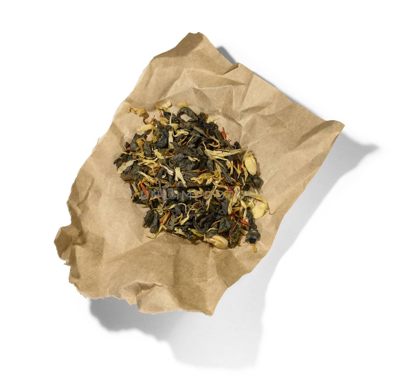 Green tea with aromatic additives. Top view on white background.
