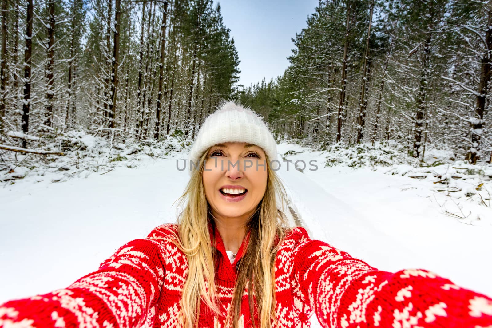 Happy woman enjoying nature outdoors in the snow