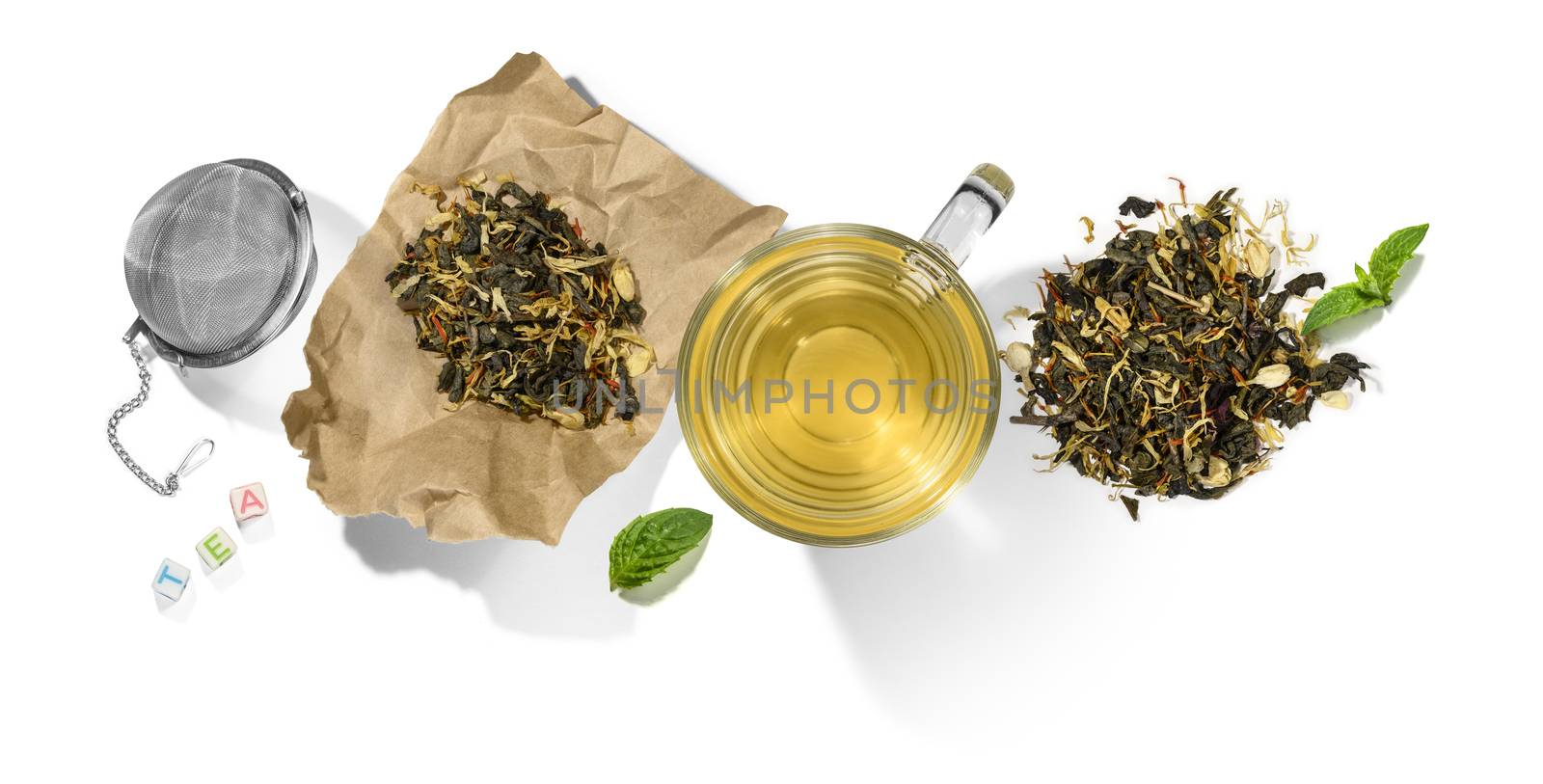 Green tea with aromatic additives and accessories. Top view on white background.