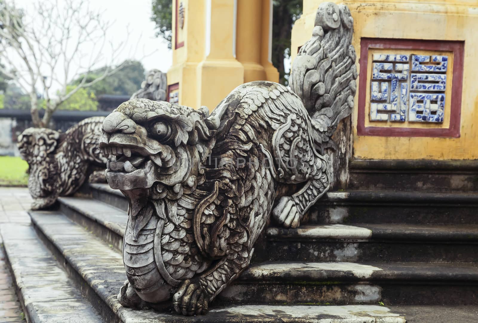 Dragon-shaped handrail in Hue Imperial Palace, Vietnam. The symbol of good fortune on the wall