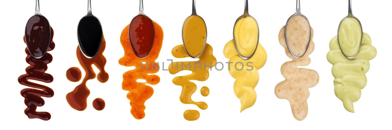 Set of different sauces with spoons isolated on white background with clipping path