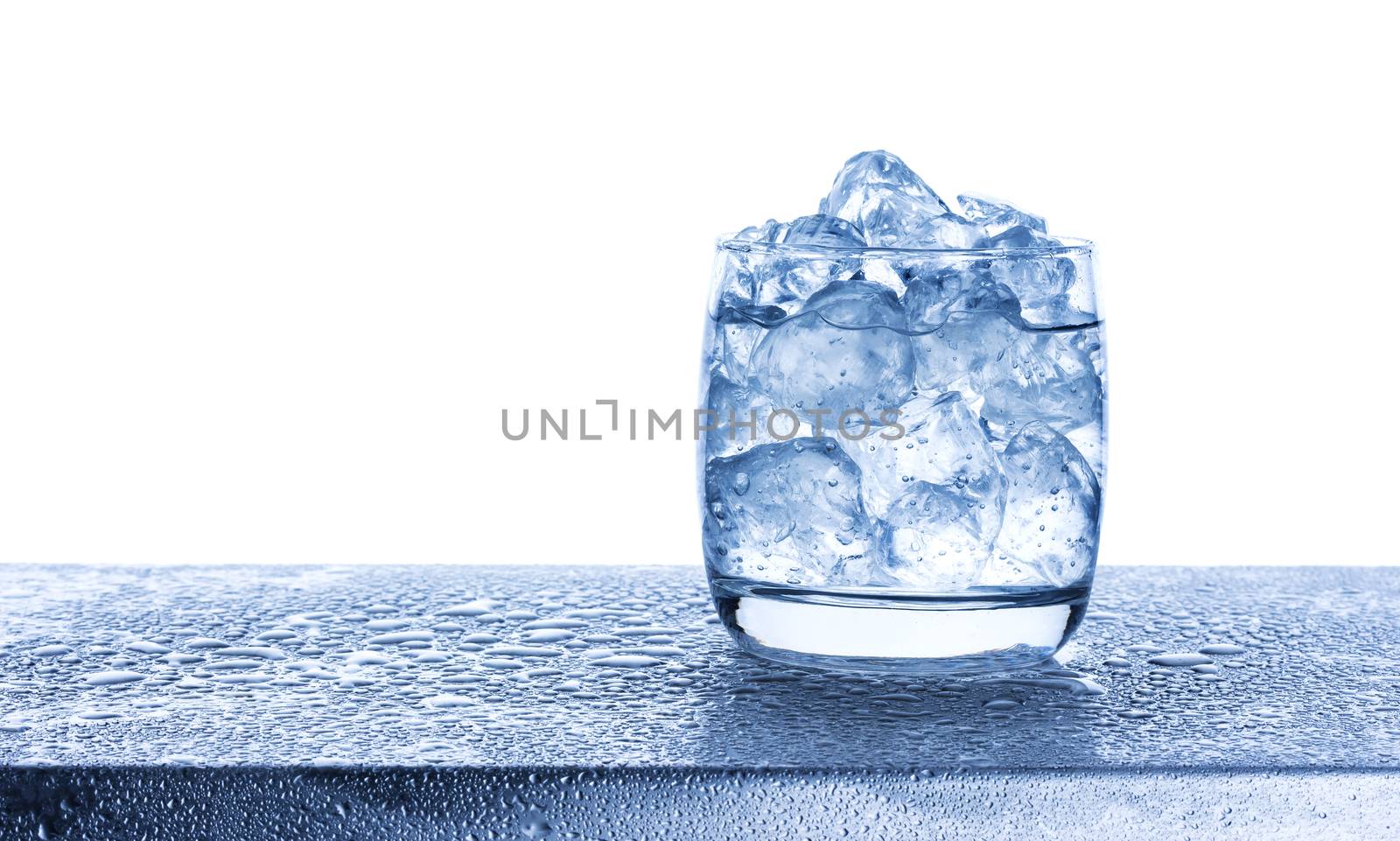 Water with crushed ice cubes in glass isolated on white background with copy space