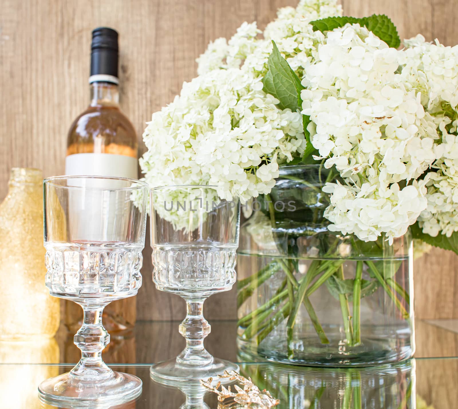 Rose blush wine in glasses. Bottle of rose wine with flowers on background. Prosecco.