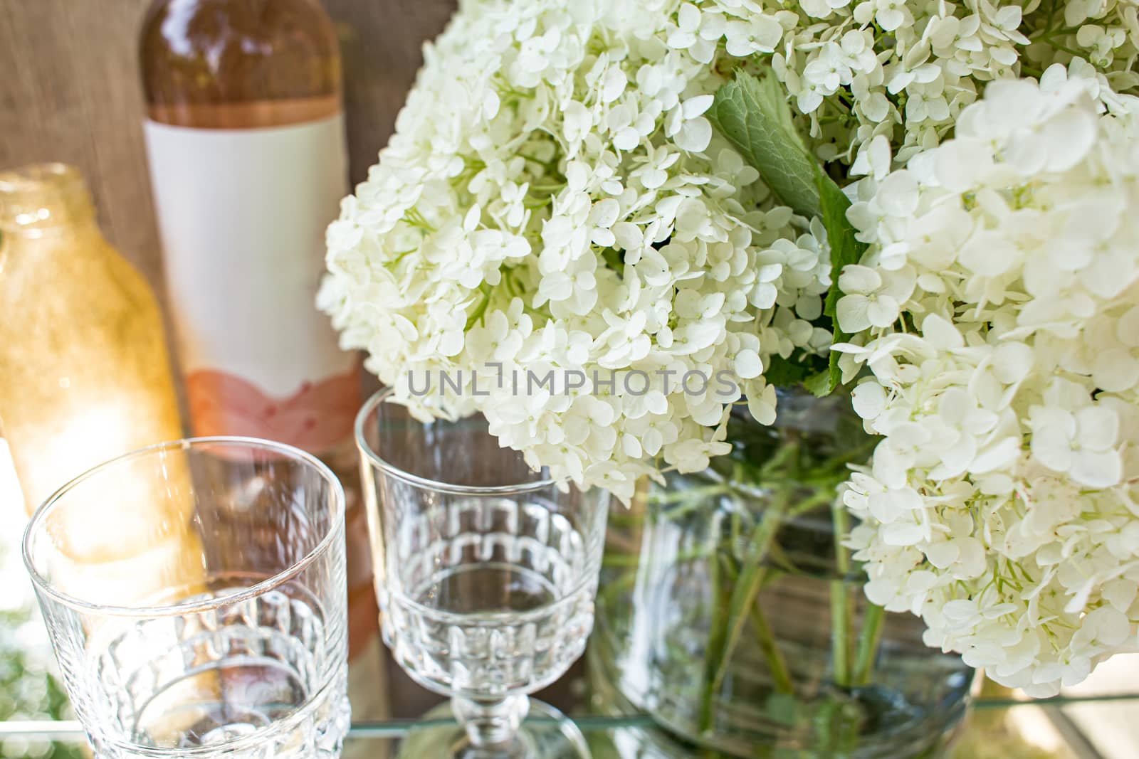 Rose blush wine in glasses. Bottle of rose wine with flowers on background. Prosecco. by Denys_N