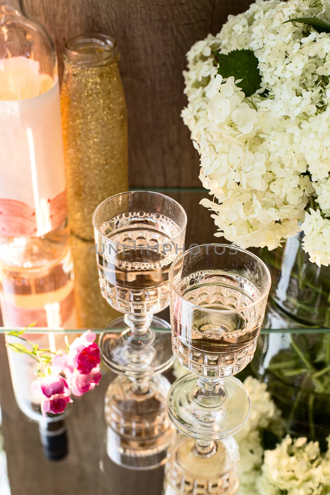 Rose blush wine in glasses. Bottle of rose wine with flowers on background. Prosecco. by Denys_N