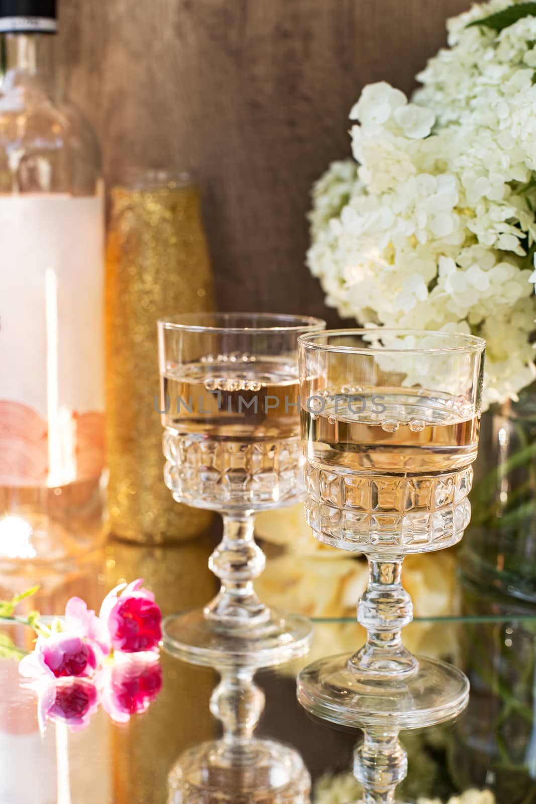 Rose blush wine in glasses. Bottle of rose wine with flowers on background. Prosecco. by Denys_N