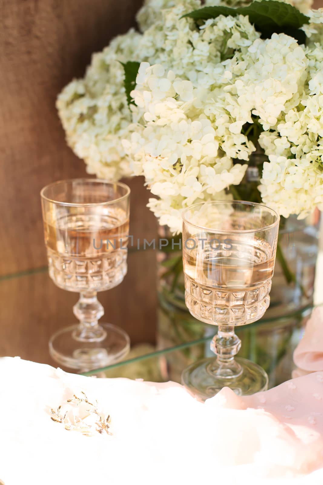 Rose blush wine in glasses. Bottle of rose wine with flowers on background. Prosecco.