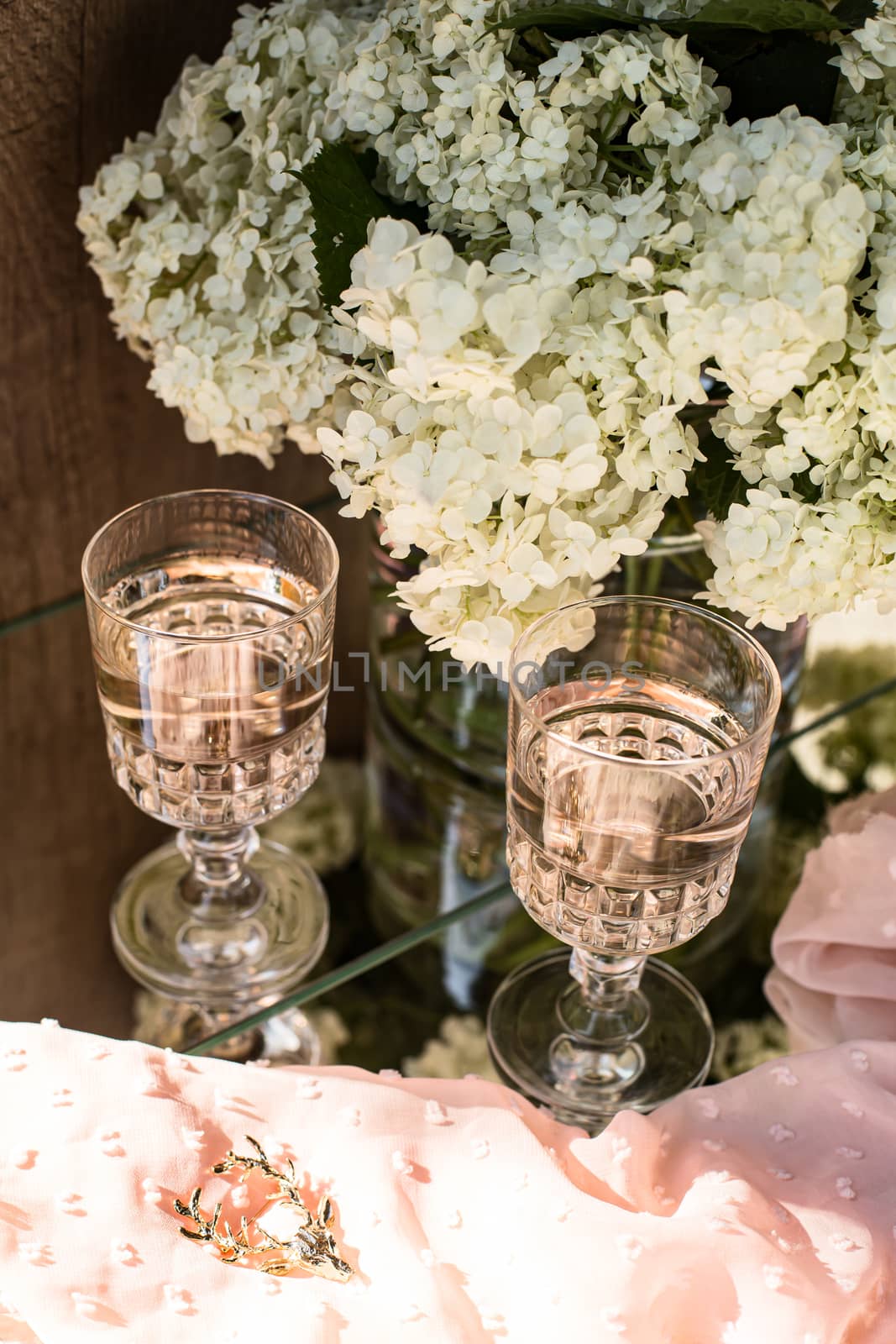 Rose blush wine in glasses. Bottle of rose wine with flowers on background. Prosecco.