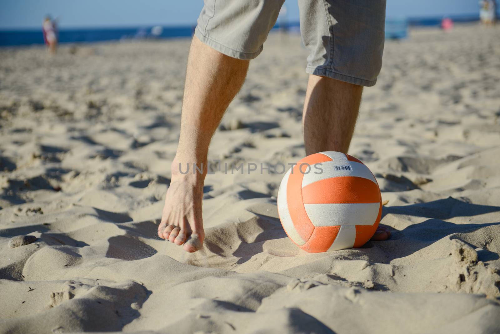 man playing soccer on beach with dribble skill and ball on vacation