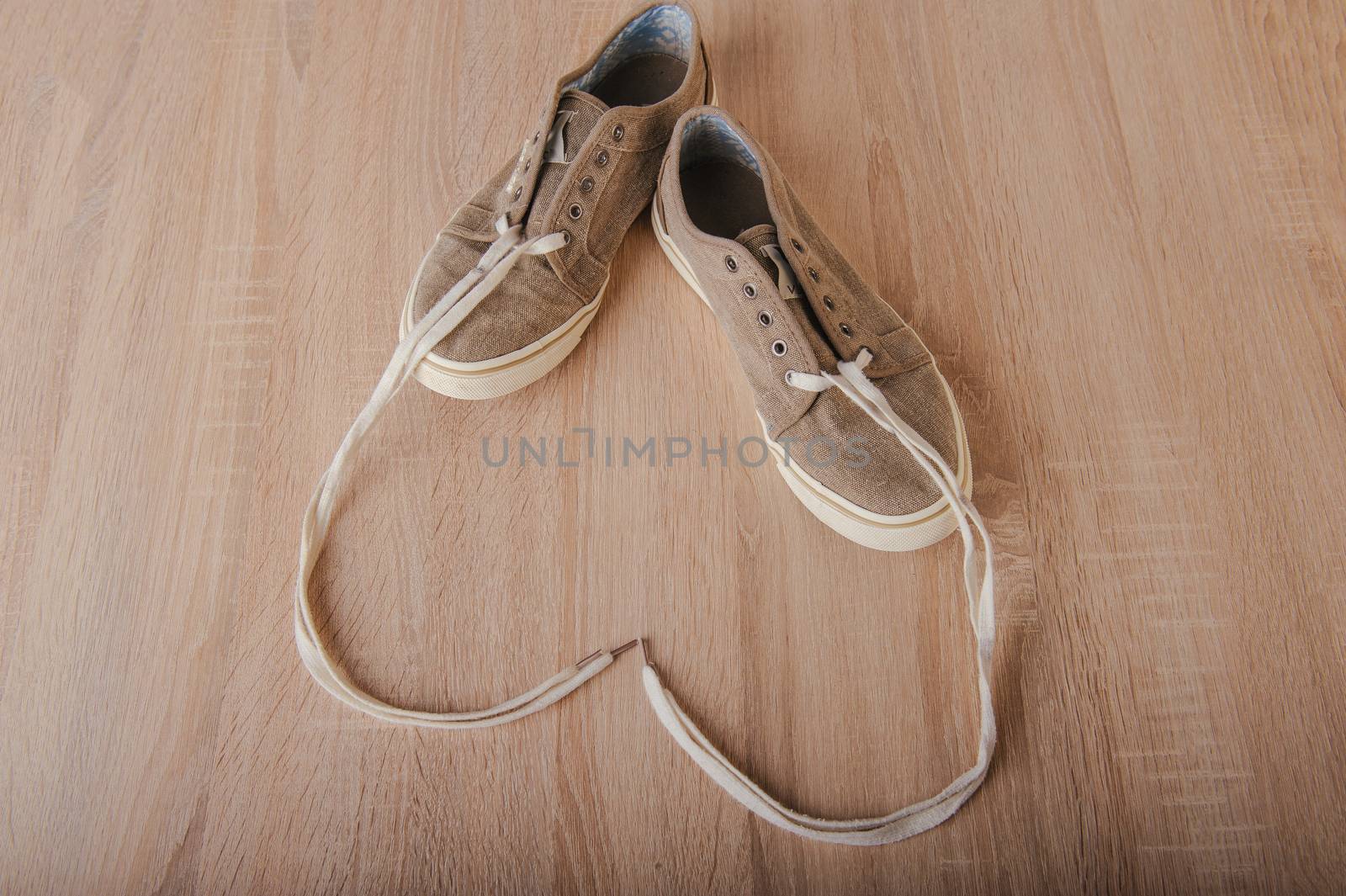 Blue lovely used sneakers on wooden desk