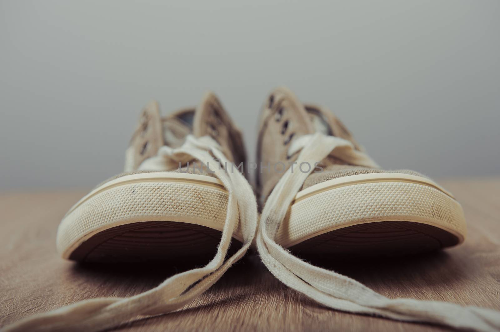 Blue lovely used sneakers on wooden desk