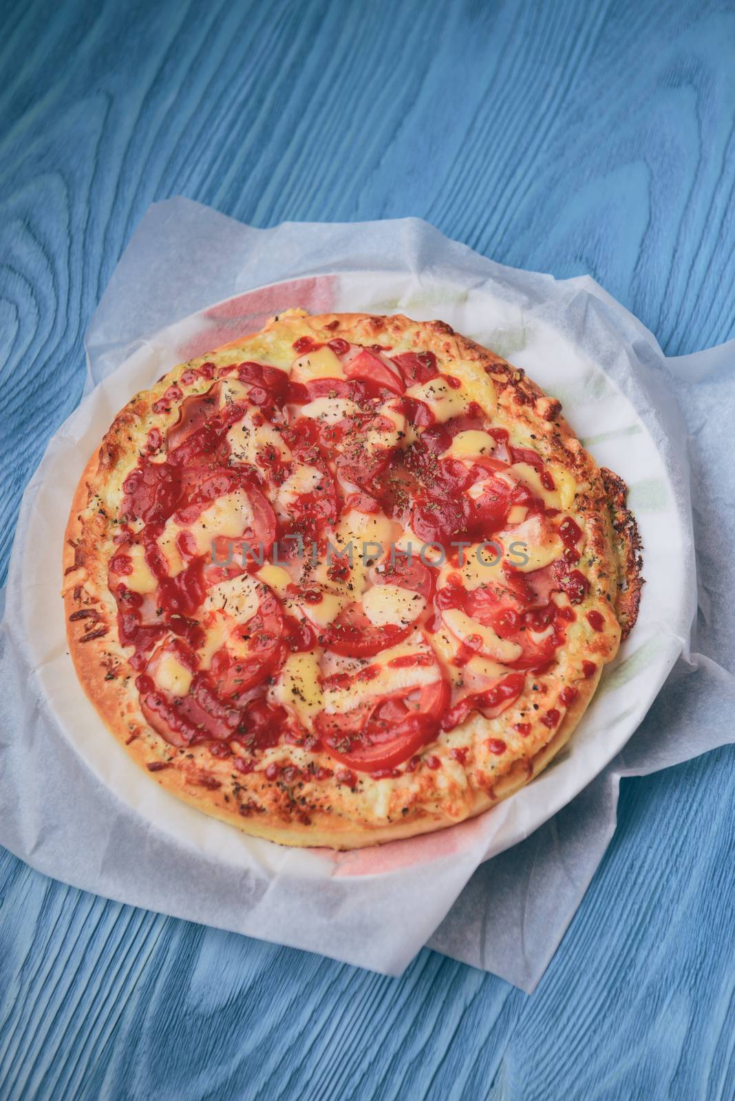 Homemade pepperoni pizza on the table. Tomato, cheese and ham main ingredients.