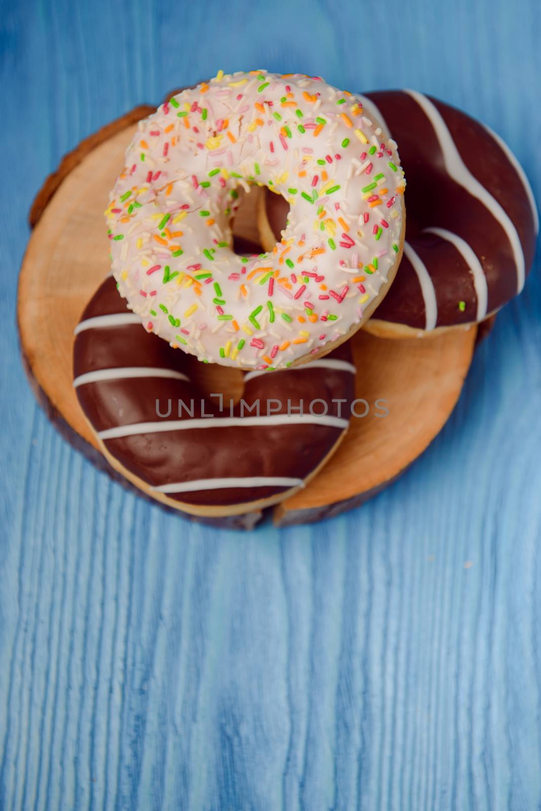 donuts lying on the table. blue background.