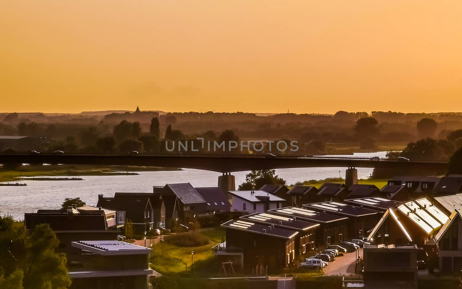 view on modern houses and the city bridge in rhenen during sunset, Rustic town in the Netherlands