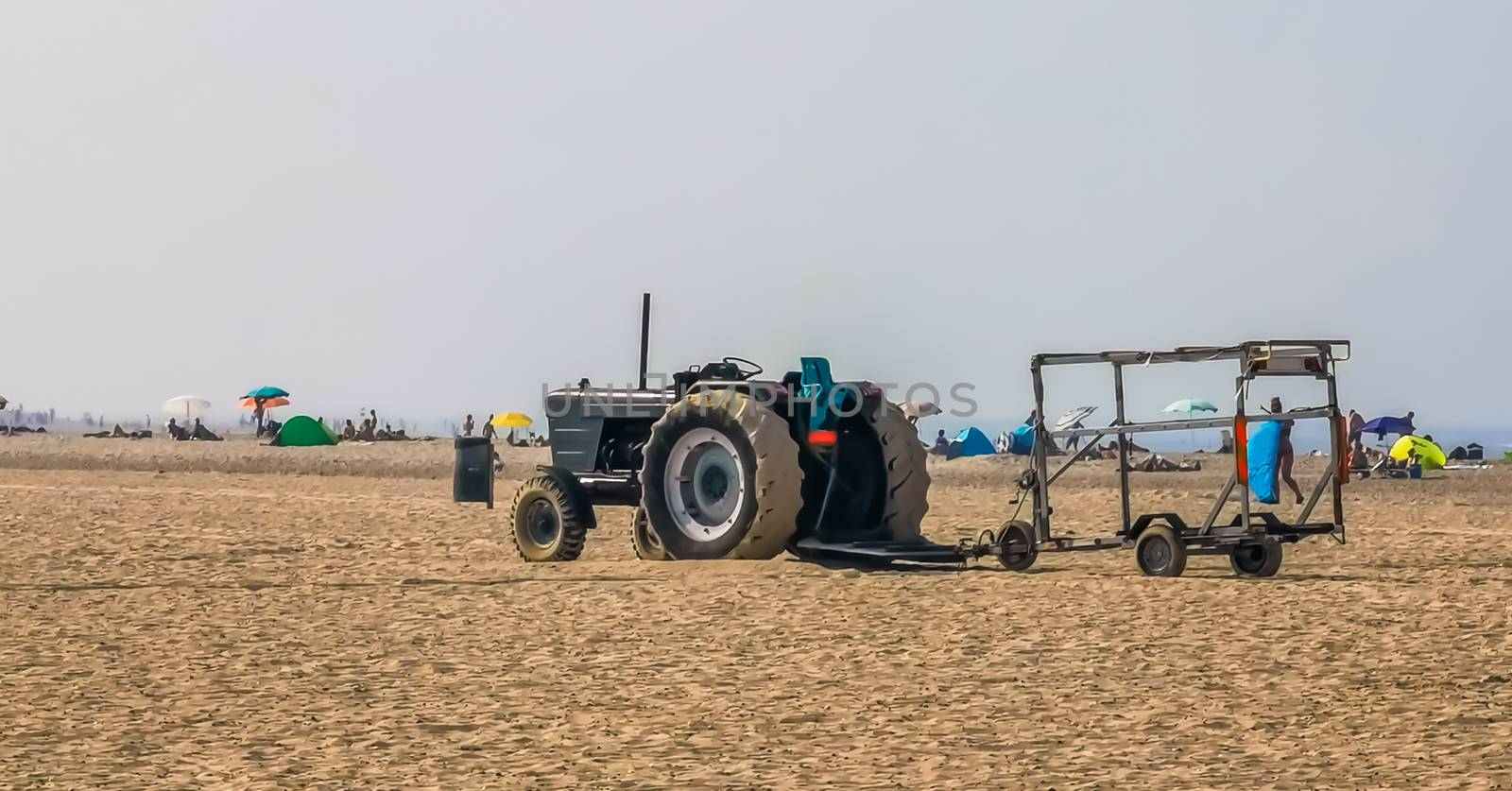 beach tractor with trailer parked on the beach of vrouwenpolder, zeeland, The netherlands