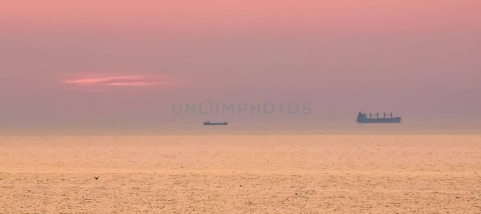 boat sailing on the ocean during sunset, Domburg, Zeeland, The netherlands by charlottebleijenberg