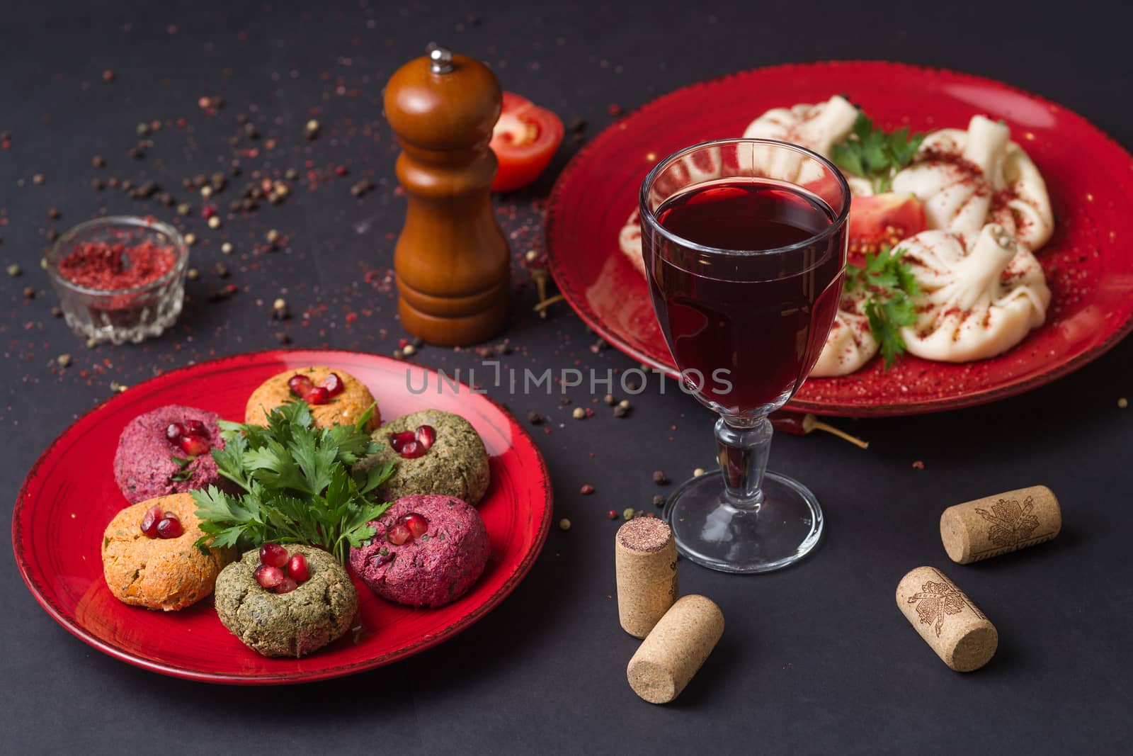 Georgian food on black table. khinkali, phali,  khachapuri with tomatos and adjika