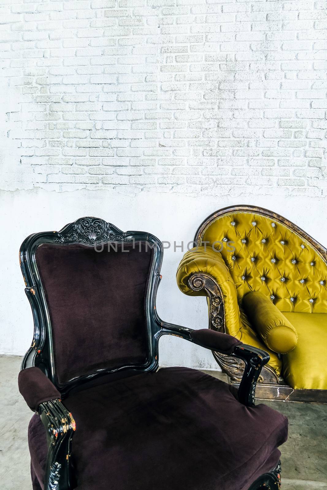 antique sofa on brick wall background by ponsulak