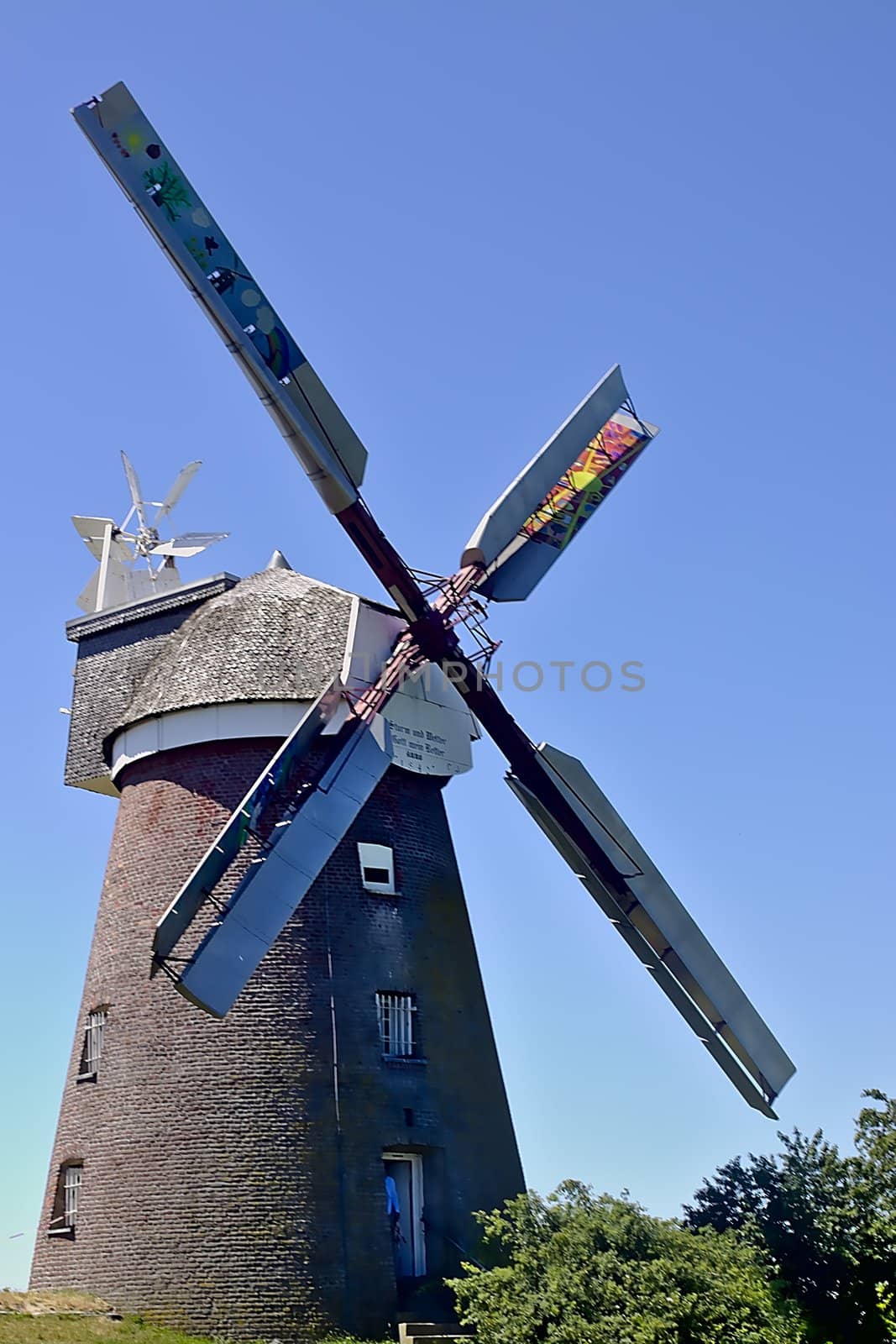 A nicely restored windmill on a beautiful sunny day in june.
