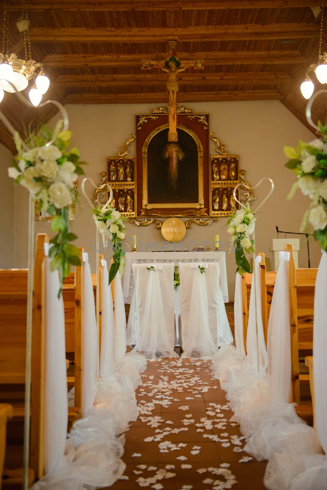 Church sanctuary before a wedding ceremony. Empty chairs for bride and groom