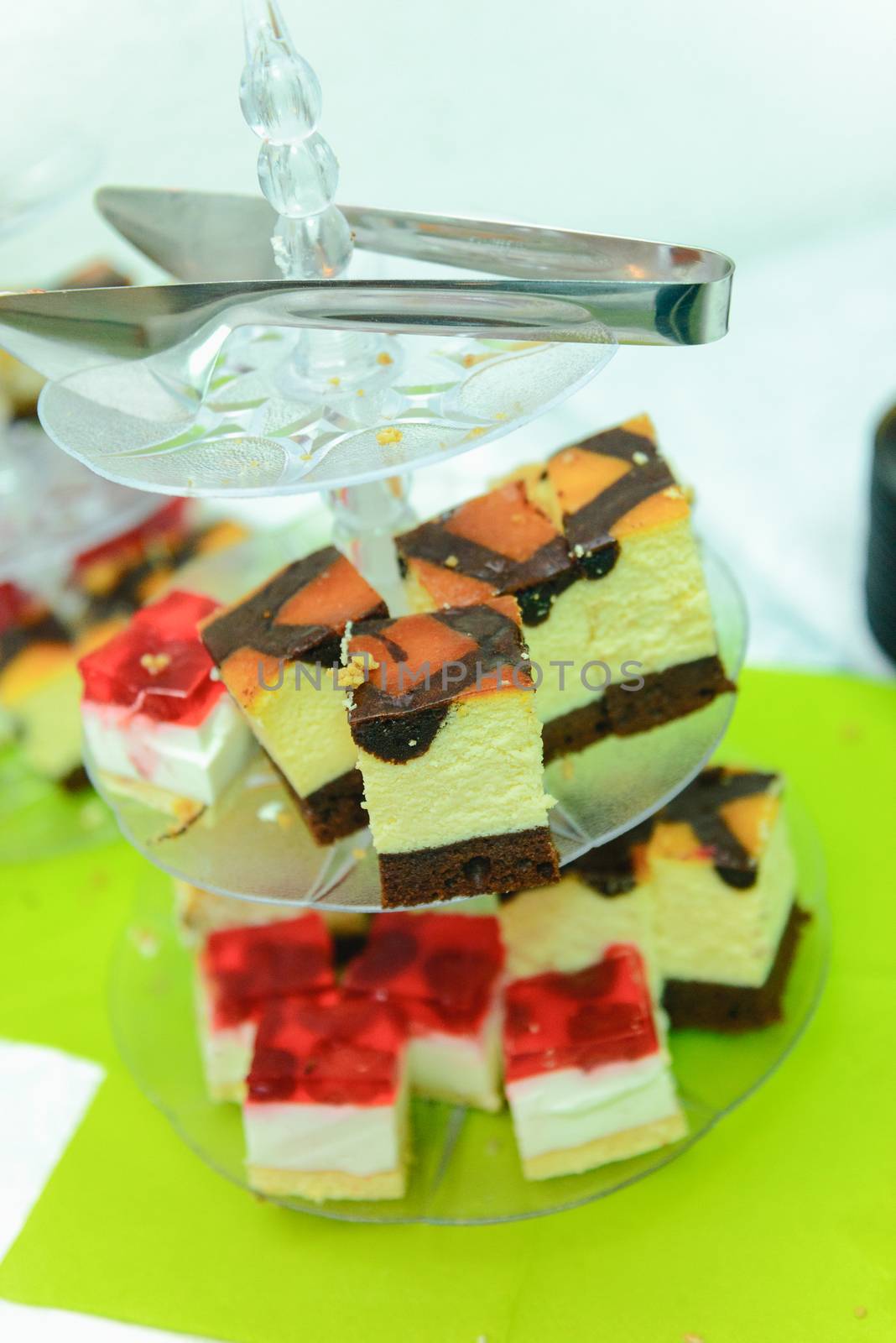 Delicious sweets on candy buffet. Wedding bakes on trays.