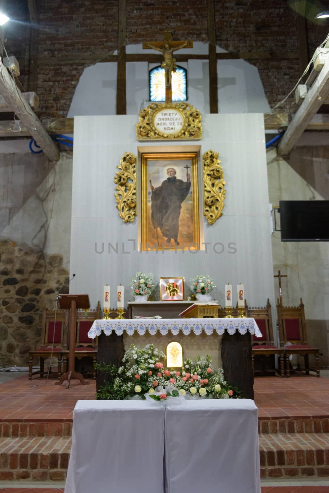 Church sanctuary before a wedding ceremony. Empty chairs for bride and groom