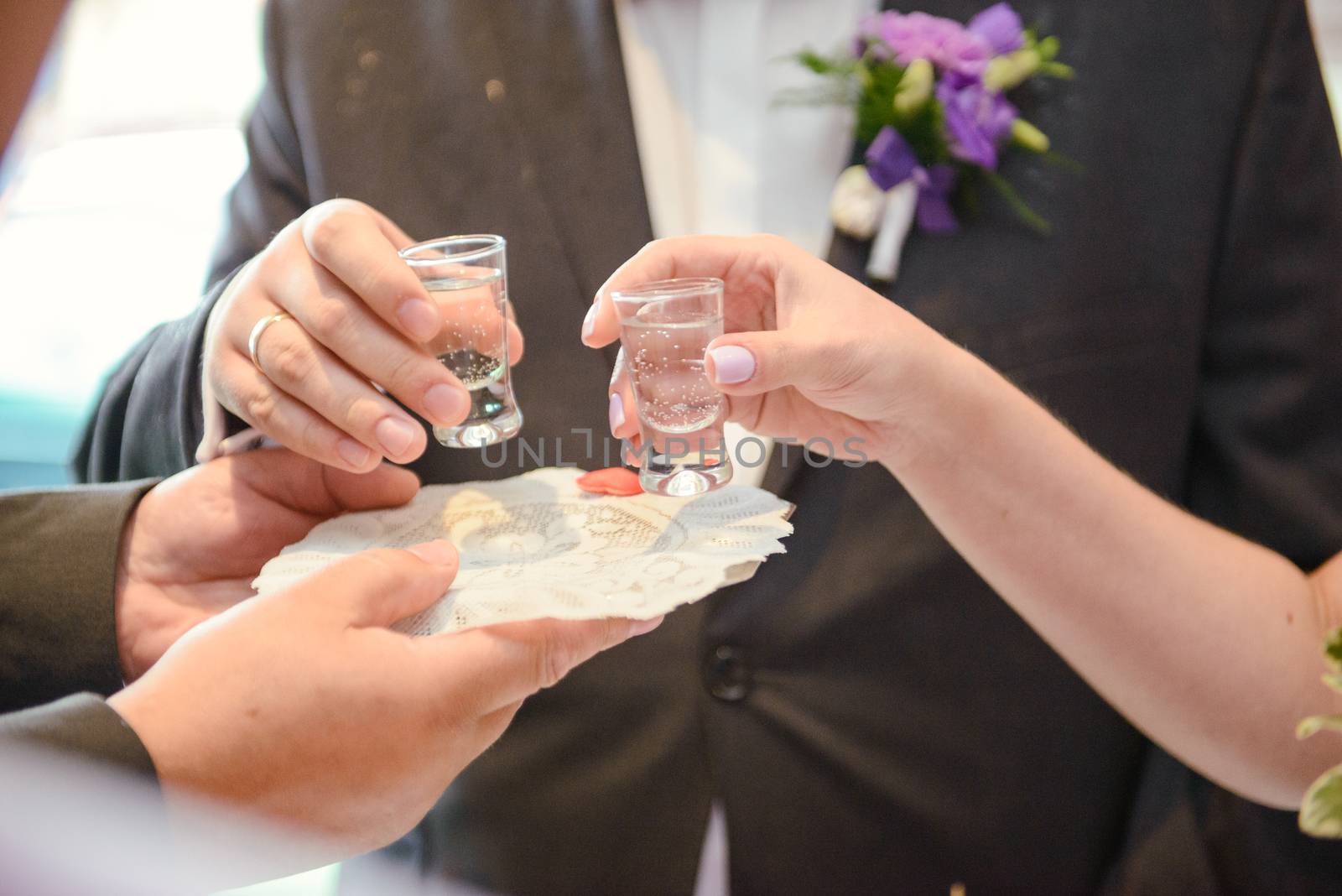 Traditional polish greeting the bride and groom by the parents with bread and salt. Vodka also in glasses.
