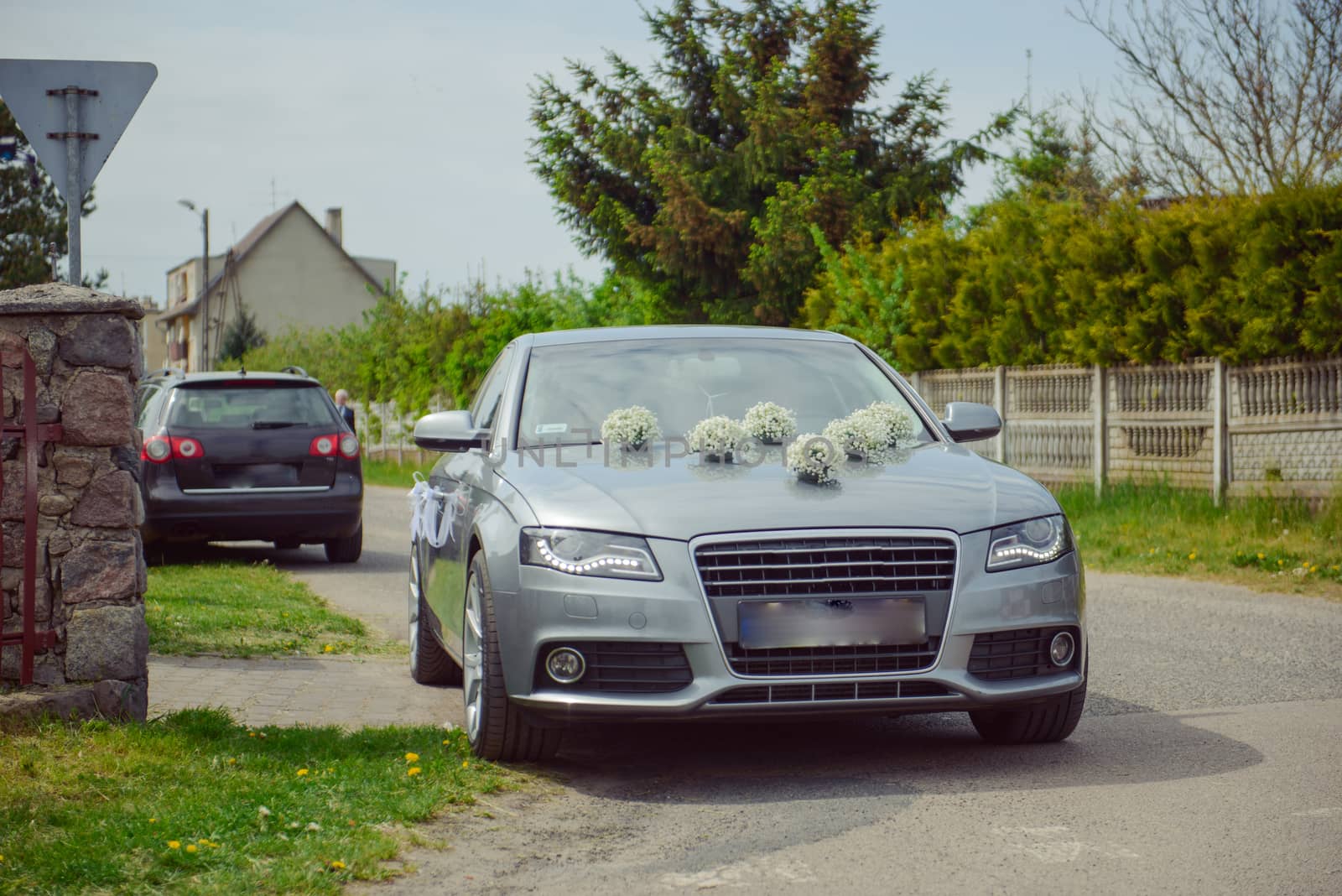 Luxury wedding car decorated with beautiful flowers. Brides and grooms wedding day