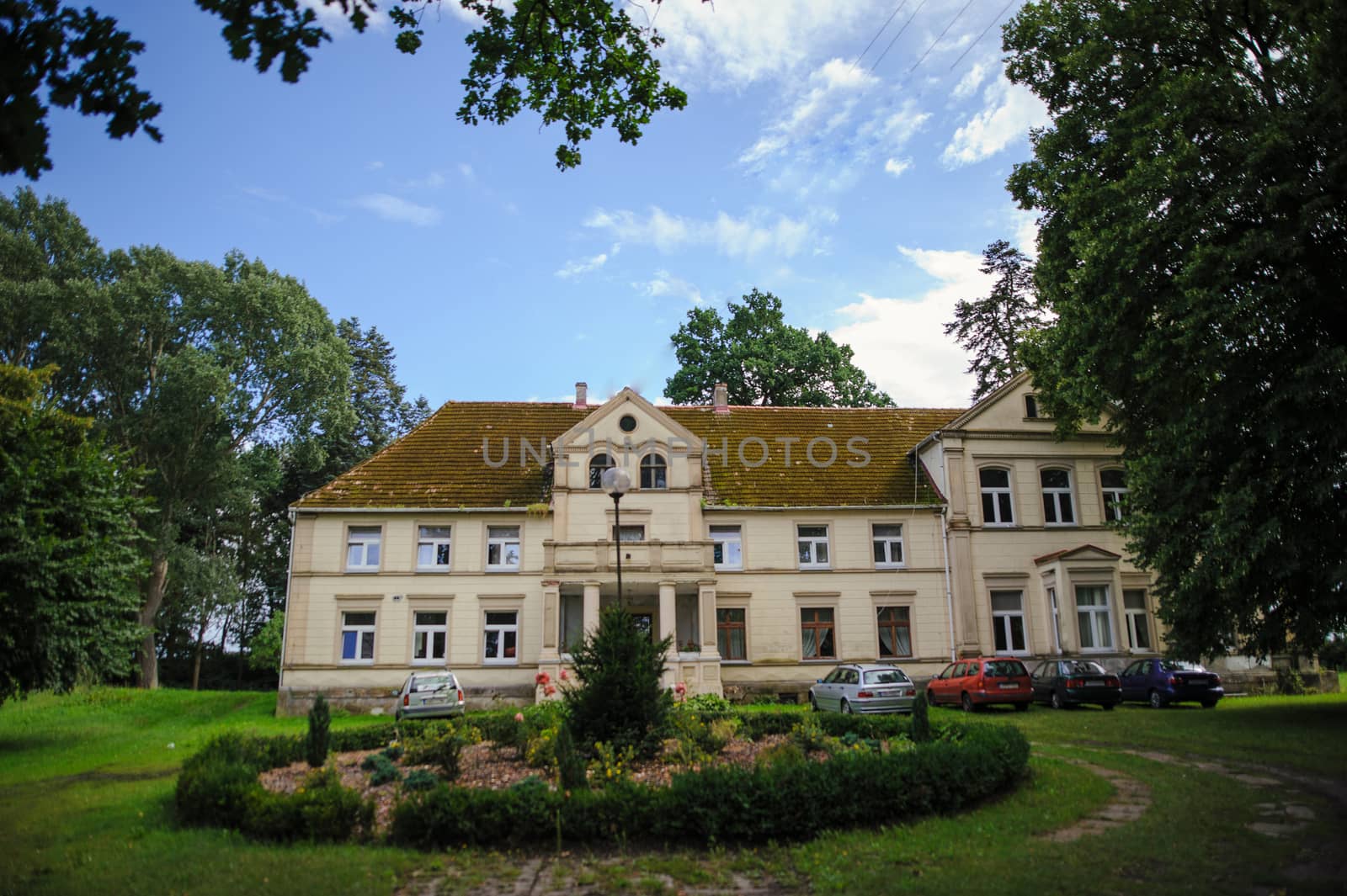 Renaissance historic palace in Poland, surrounding by beautiful green garden