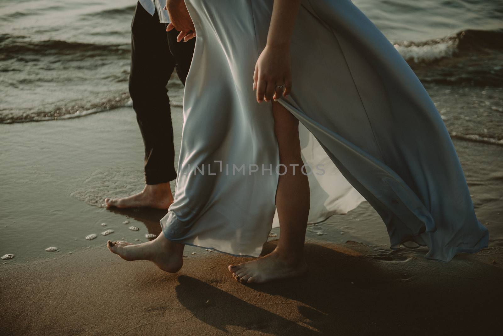 Bride and groom at a photo session in the nature. Baltic sea beach.