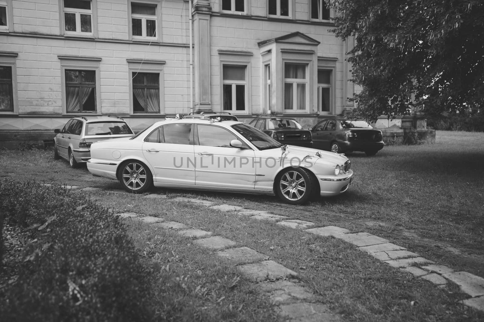 Luxury wedding car decorated with beautiful flowers. Brides and grooms wedding day