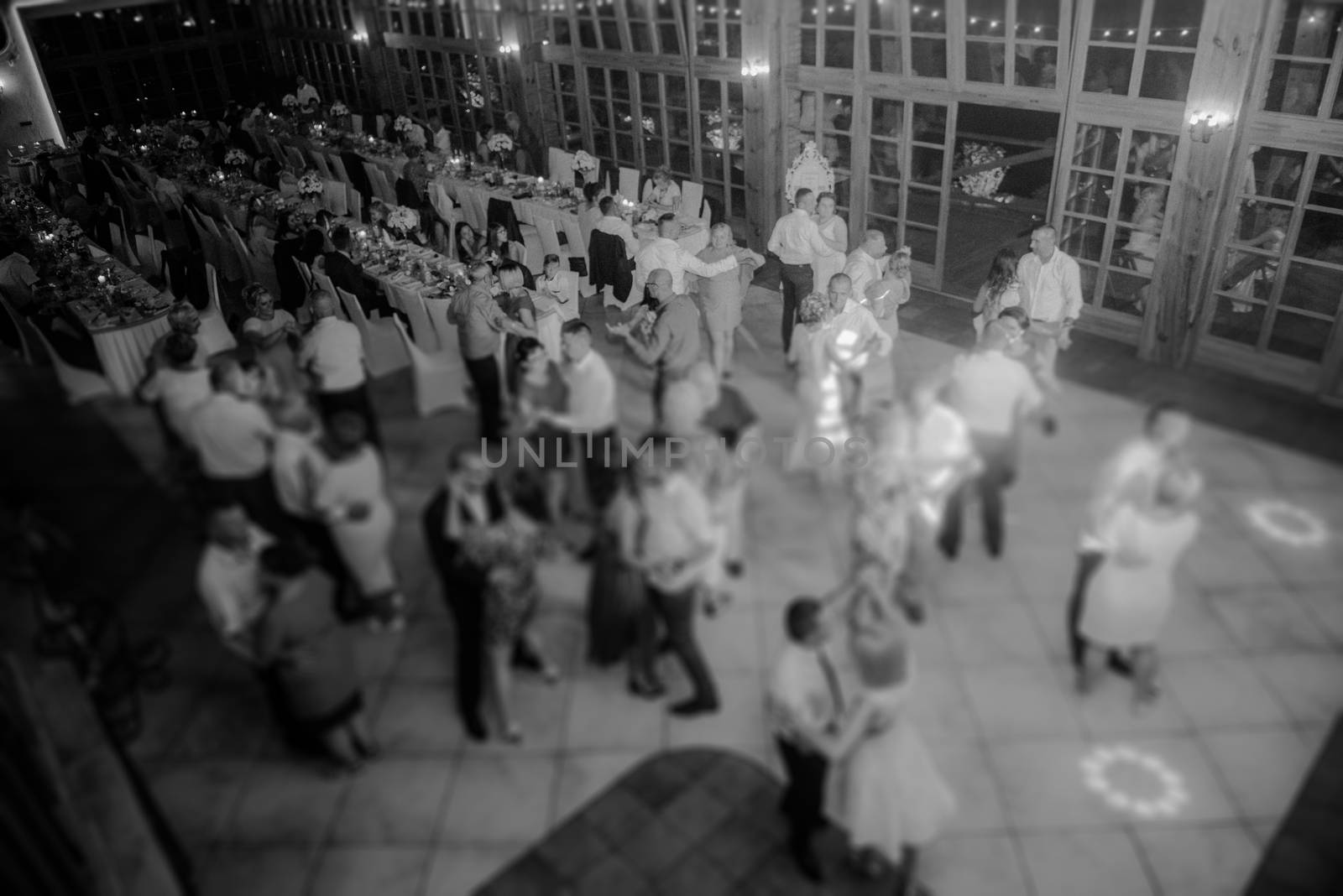 Bride and groom dancing the first dance at their wedding day. Guest on the dancefloor