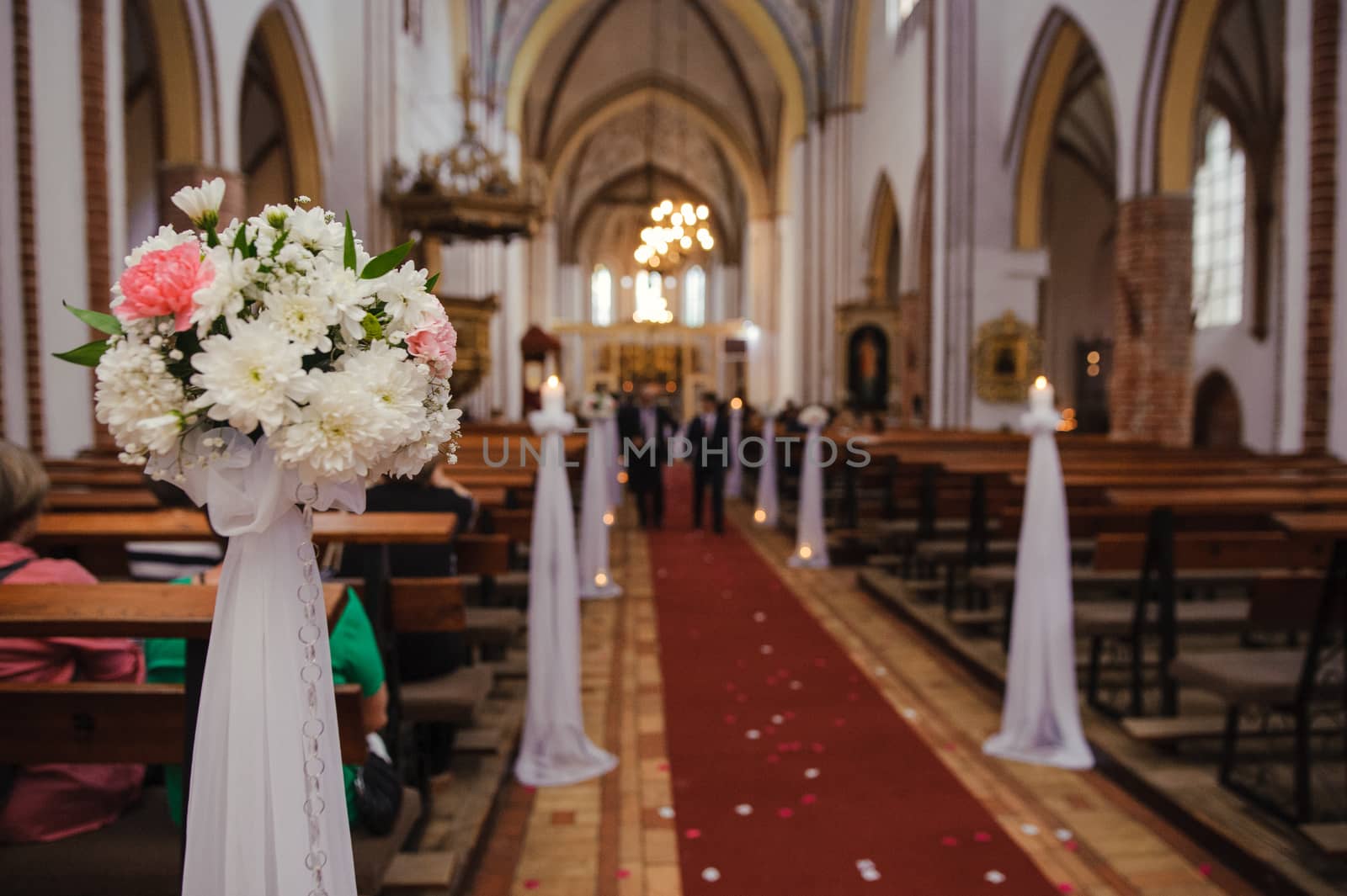 Church sanctuary before a wedding ceremony. Empty chairs for bride and groom