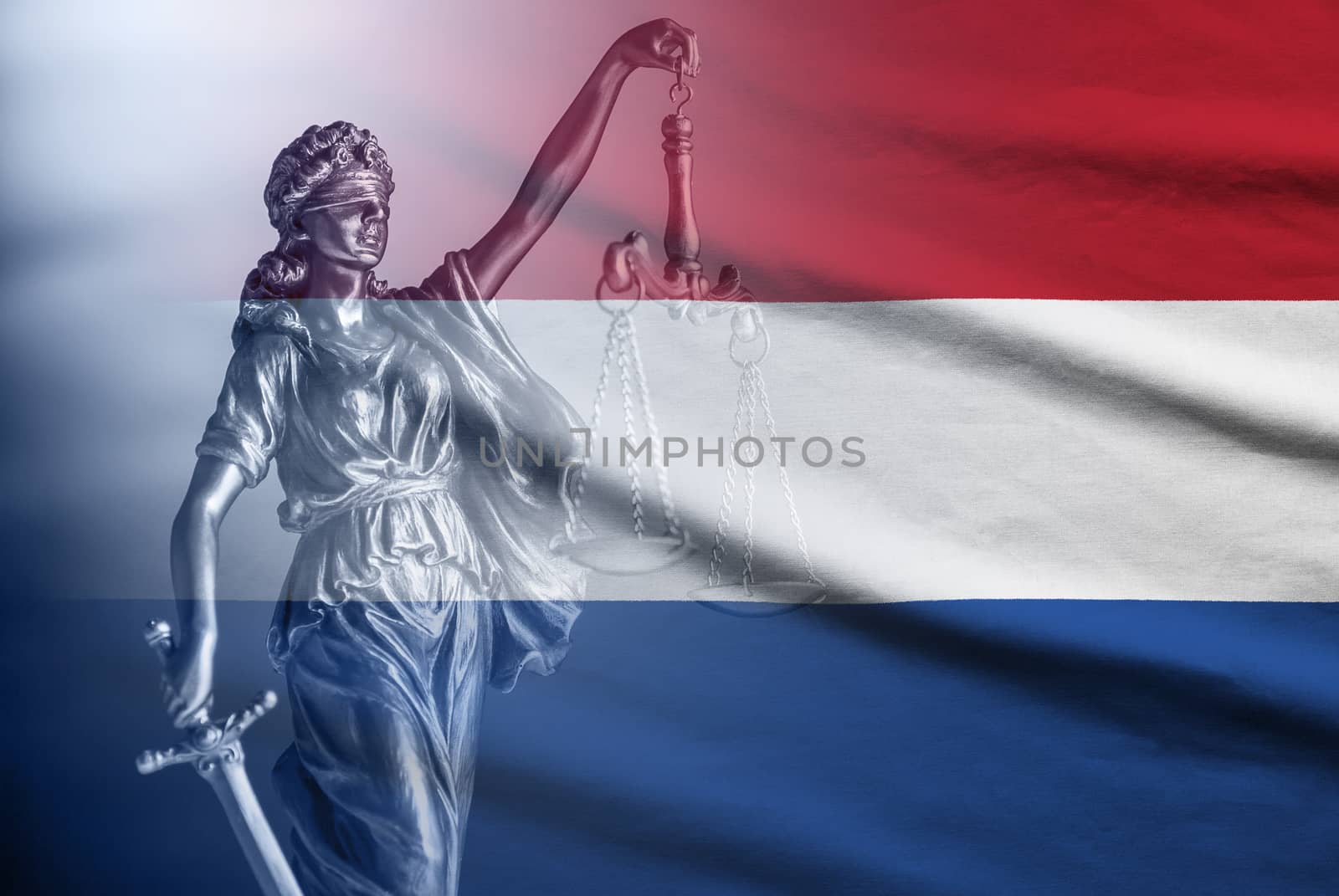 Statue of a blindfolded Justice on a flag of Netherlands holding scales and sword in a concept of law and impartiality