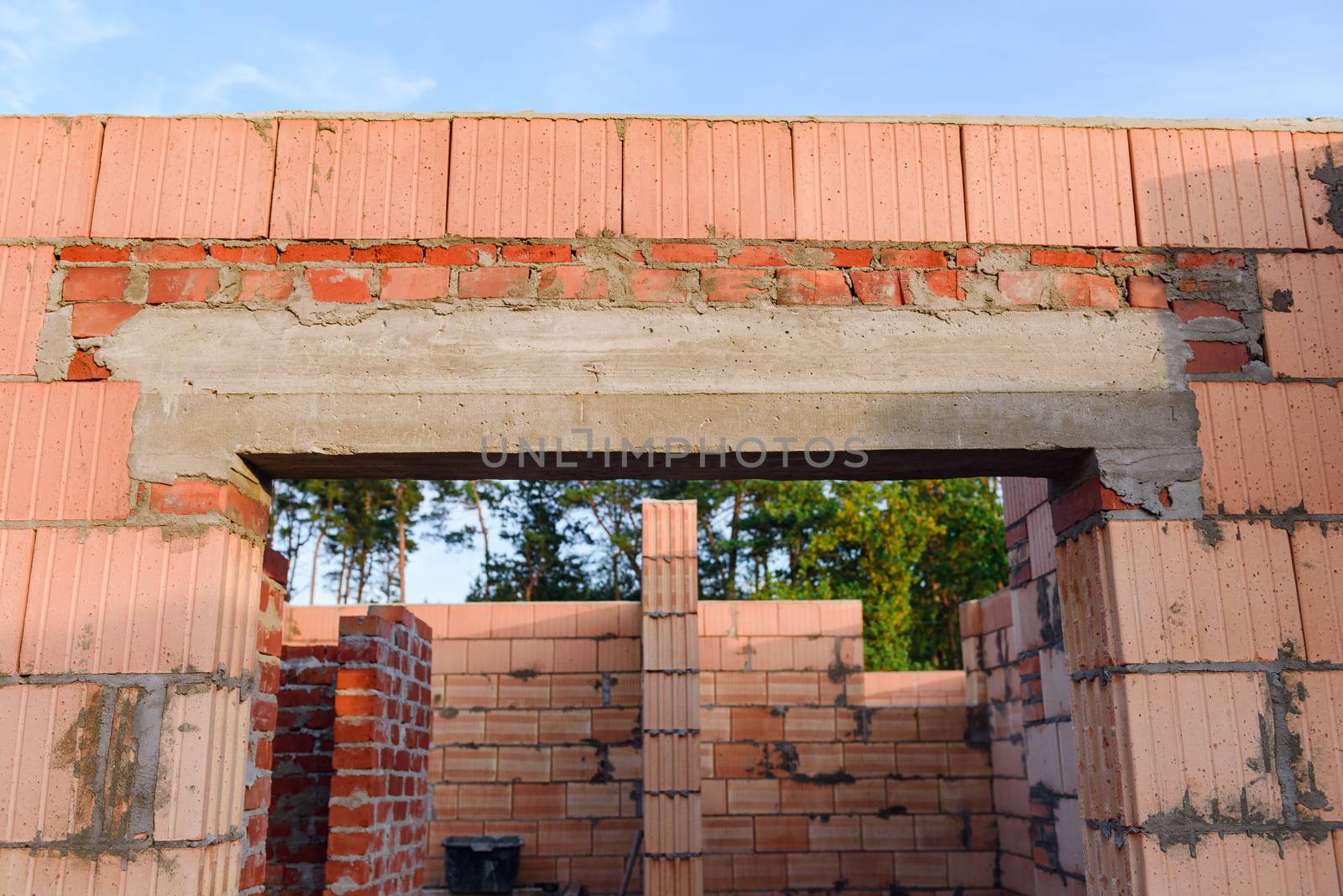 Interior of a Unfinished Red Brick House Walls under Construction without Roofing.