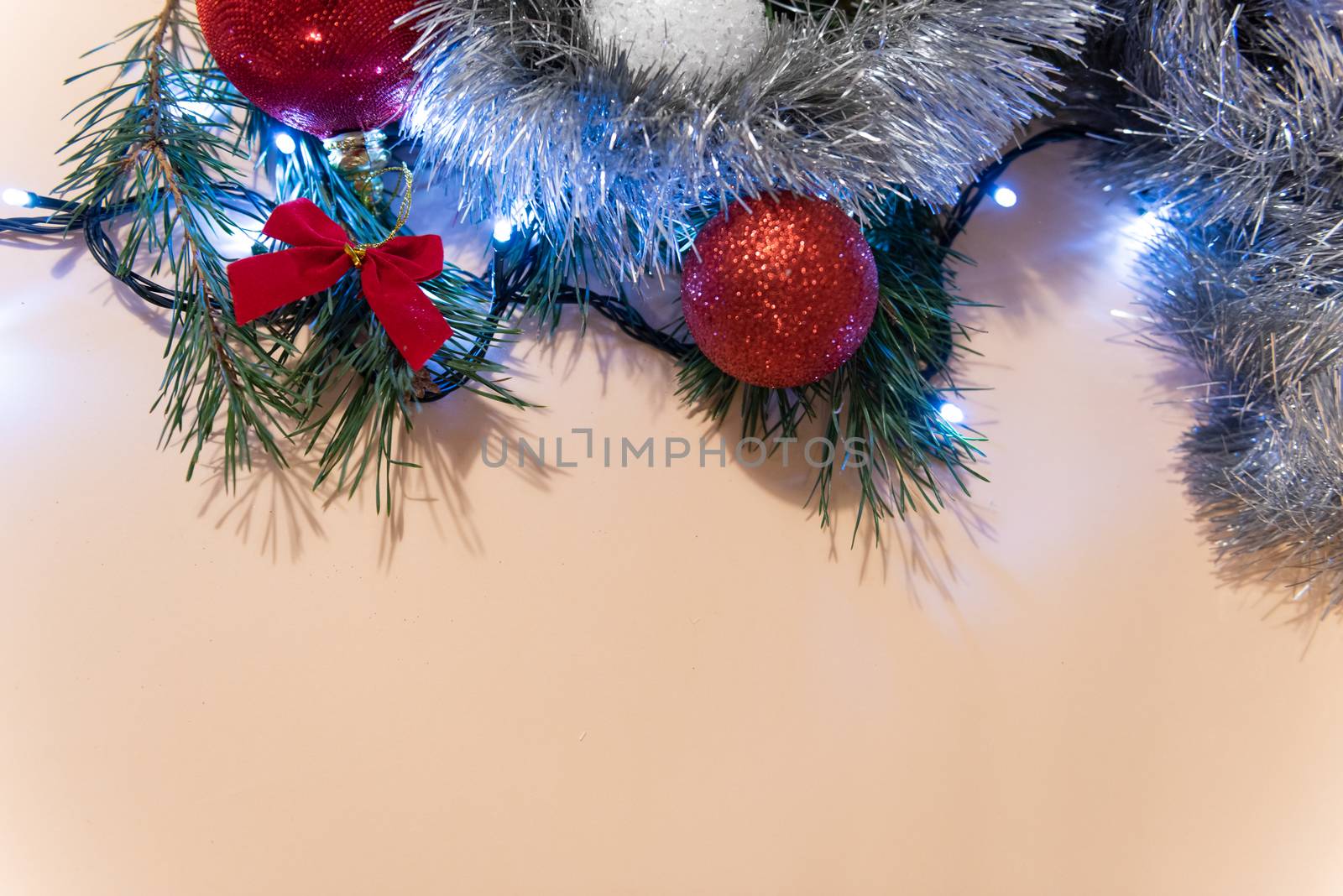 Christmas or New Year background, plain composition made of Xmas decorations and fir branches, flat lay, blank space for a greeting text.