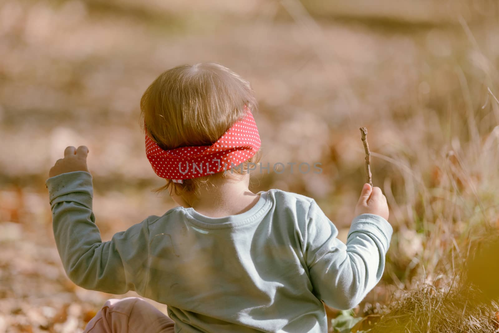 Adorable girl having fun on beautiful autumn day. authentic childhood image