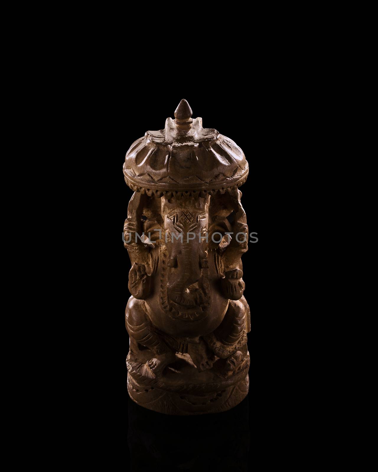 A low light photo of indian god Ganesh statuette. Figurine made  by alexsdriver
