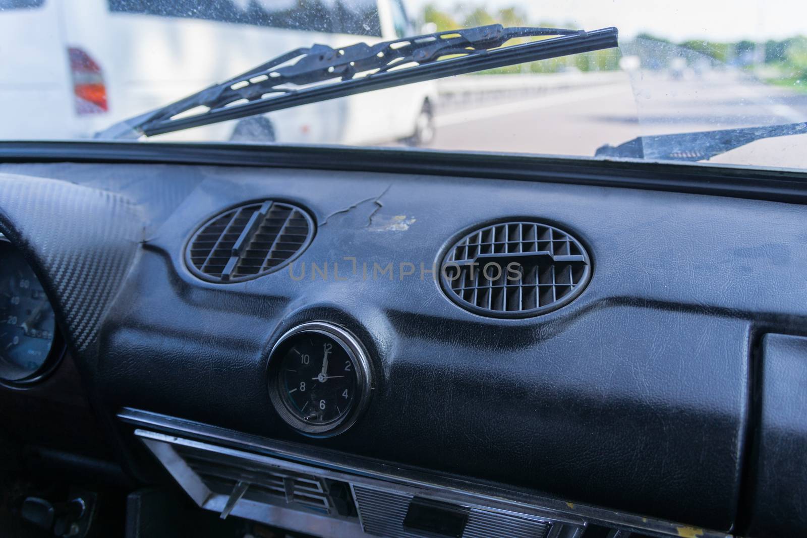 View of a passenger from the passenger compartment on the highway. A fine sunny day and almost free road. 