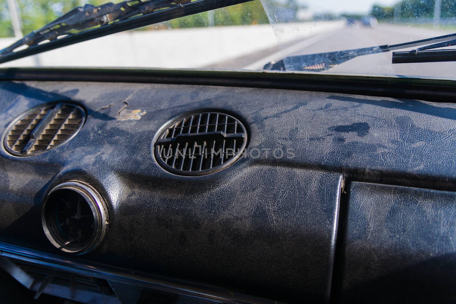 View of a passenger from the passenger compartment on the highway. A fine sunny day and almost free road. 