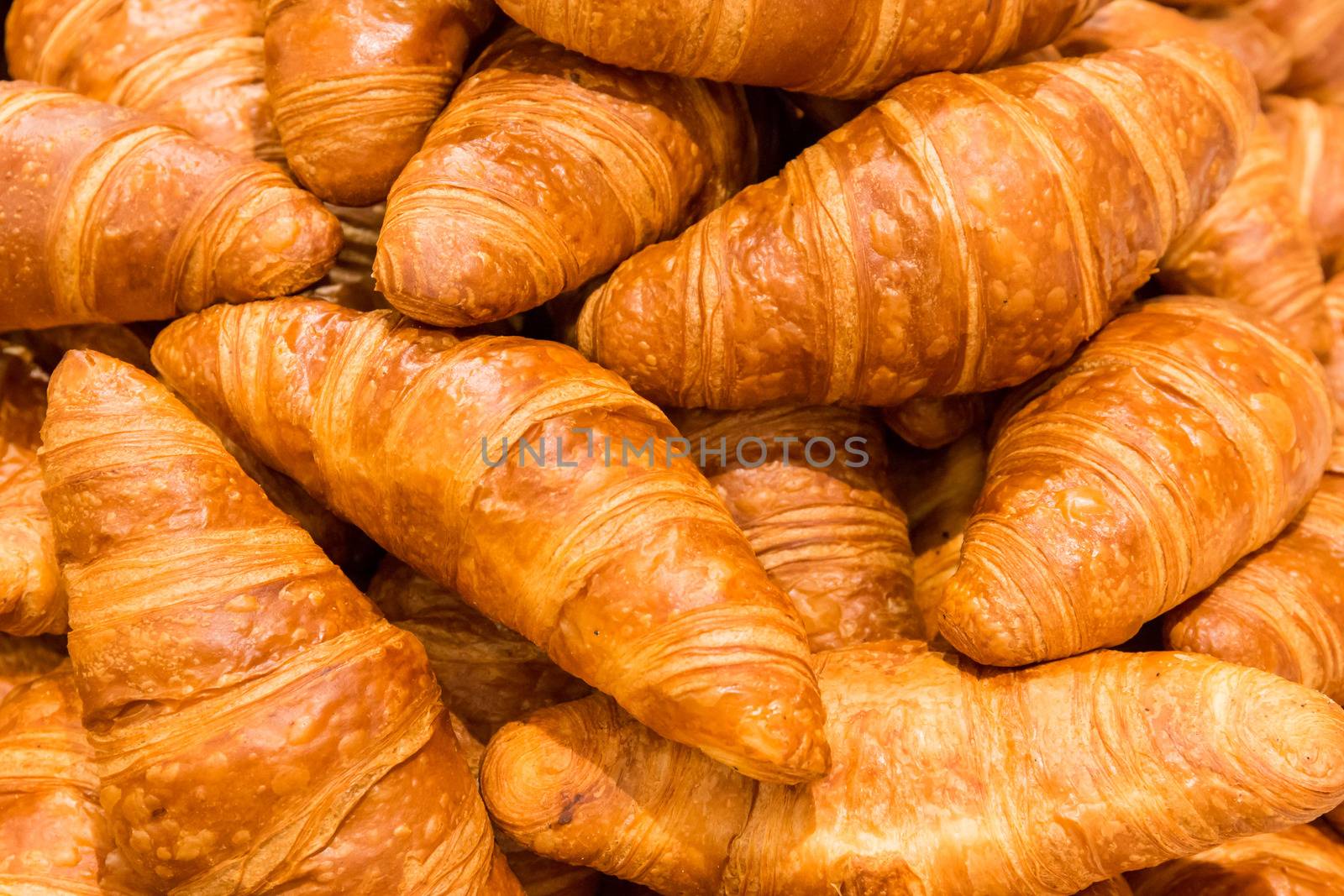 Heap of fresh baked mouthwatering butter croissant pastries, Food texture background. Puff pastry filled frame. by petrsvoboda91