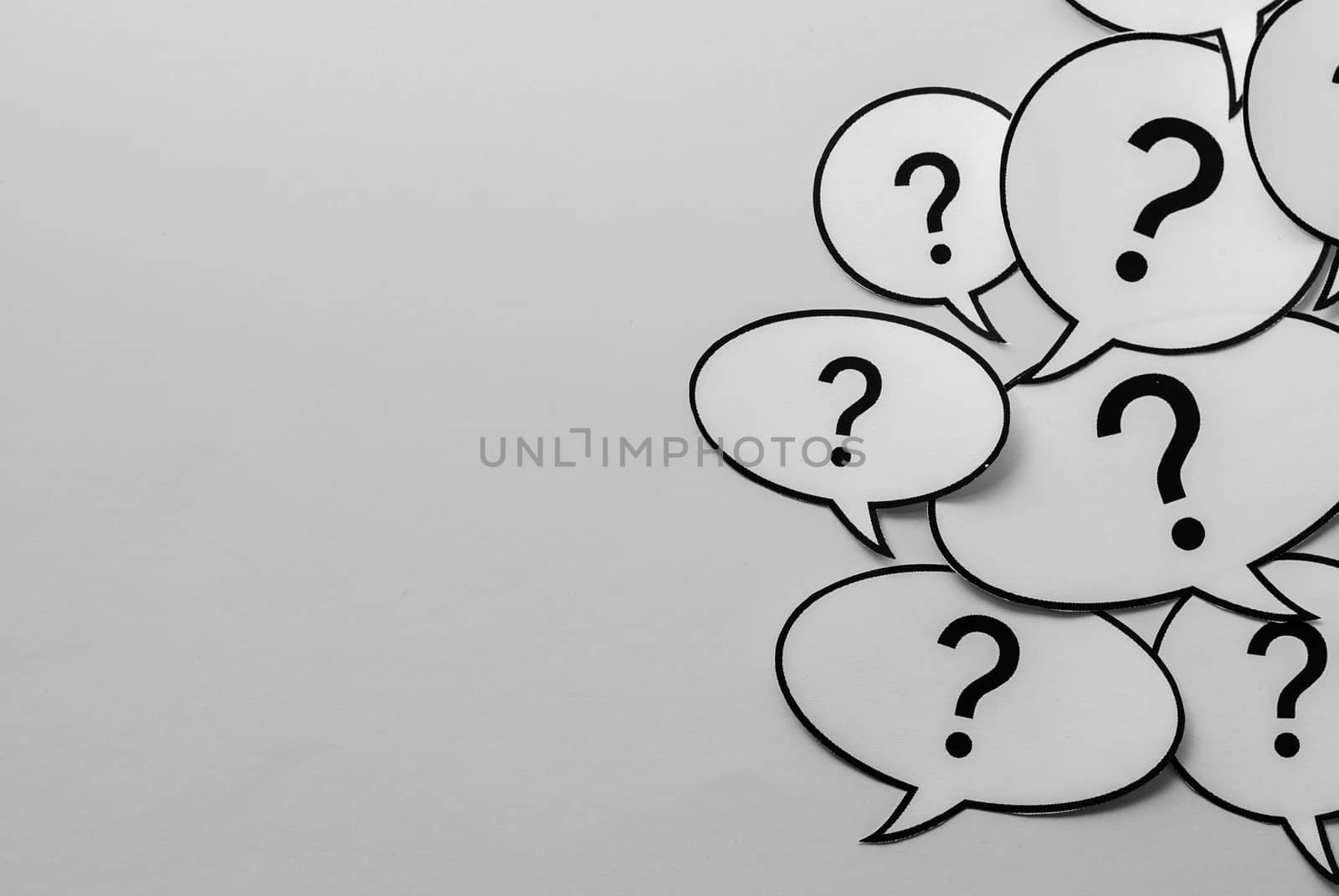 Question marks on speech bubbles side border over a white background with copy space in a communications concept